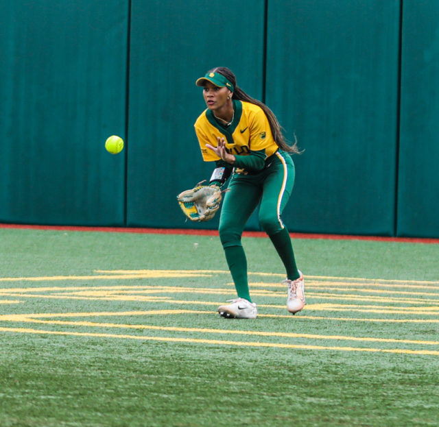 Junior outfielder McKenzie Wilson (21) keeps her eye on the ball as she snags a line drive to center field during the championship game of the Baylor Invitational against the University of Minnesota, Sunday, at Getterman Stadium.