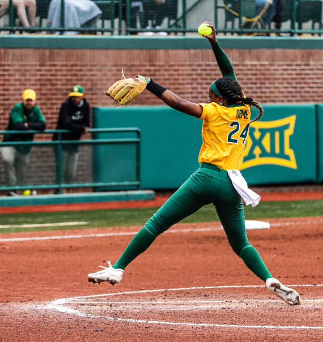 Junior right-handed pitcher Dariana Orme (24) extends out and hurles a pitch toward the catcher during the championship game of the Baylor Invitational against the University of Minnesota, Sunday, at Getterman Stadium.