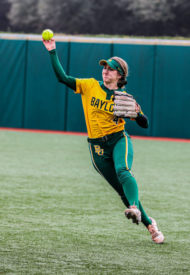 Junior utility Emily Hott (4) darts the ball toward a teammate during the championship game of the Baylor Invitational against the University of Minnesota, Sunday, at Getterman Stadium.