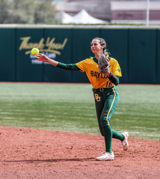 Sophomore infielder Presleigh Pilon (16) launches the ball toward a teammate during the championship game of the Baylor Invitational against the University of Minnesota, Sunday, at Getterman Stadium.