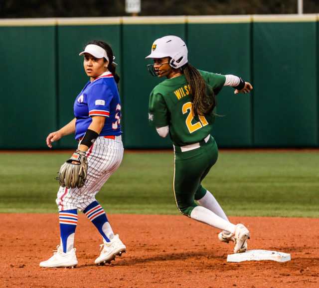 Junior outfielder McKenzie Wilson (21) rounds second base and looks to see if she can advance further during a non-conference midweek contest against the University of Texas at Arlington, Tuesday, at Getterman Stadium. 
Kenneth Prabhakar | Photo Editor