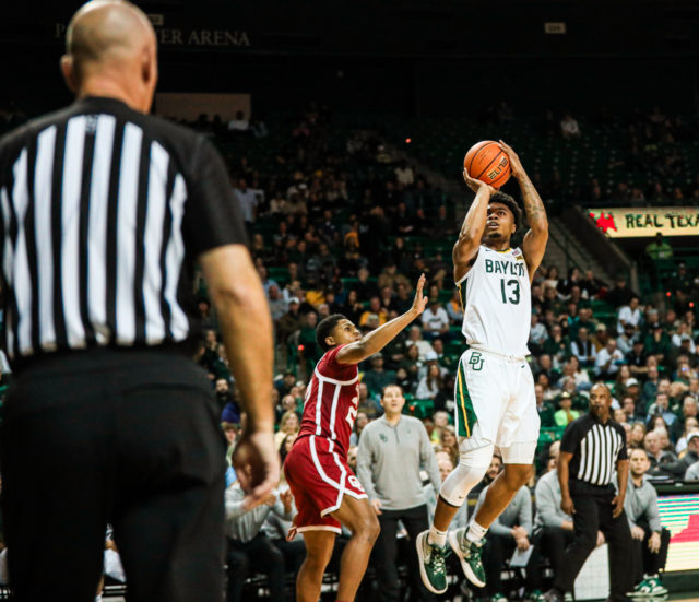 Redshirt freshman guard Langston Love (13) shoots a jump shot after pump faking his defender out of the way during a conference game against the University of Oklahoma, on Feb. 8, 2023, in the Ferrell Center. 
Kenneth Prabhakar | Photo Editor