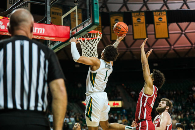 Freshman guard Keyonte George (1) rises through the lane and finishes an off-hand layup during a conference game against the University of Oklahoma, on Feb. 8, 2023, in the Ferrell Center. 
Kenneth Prabhakar | Photo Editor