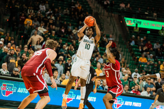 Redshirt senior guard Adam Flagler (10) stops his dribble and shoots a mid-range jumper during a conference game against the University of Oklahoma, on Feb. 8, 2023, in the Ferrell Center. 
Kenneth Prabhakar | Photo Editor