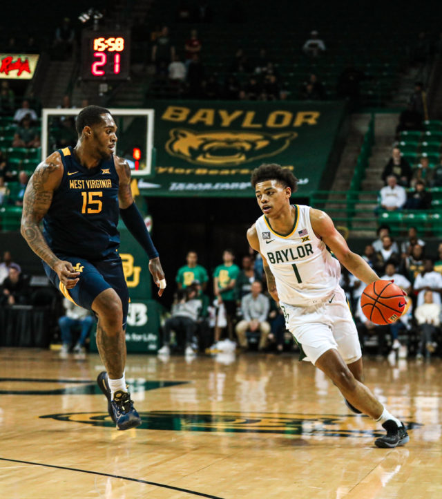 Freshman guard Keyonte George (1) plants his right foot in the hardwood and attacks the lane from the perimeter during a conference game against West Virginia University, on Feb. 13, 2023, in the Ferrell Center.
Kenneth Prabhakar | Photo Editor