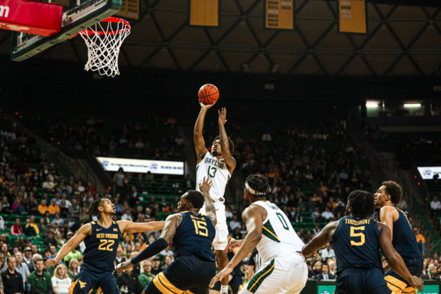 Redshirt freshman guard Langston Love (13) shoots a floater near the paint during a conference game against West Virginia University, on Feb. 13, 2023, in the Ferrell Center.Kenneth Prabhakar | Photo Editor