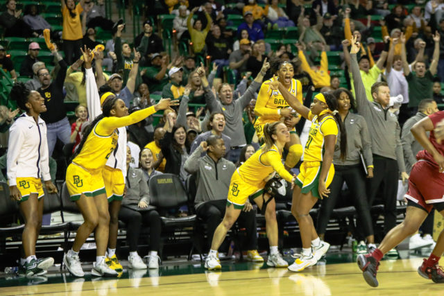 Ja'Mee Asberry celebrates with the bench after hitting a clutch three-pointer. Assoah Ndomo | Photographer.