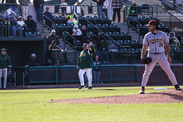 Head coach Mitch Thompson gives signals to his batters and baserunners ahead of the pitch during the first game of a non-conference series against Central Michigan University, Friday, Feb. 17, 2023, at Baylor Ballpark.
Assoah Ndomo | Photographer.
