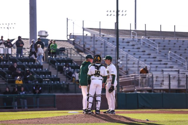 Sophomore catcher Cortlan Castle (19) talks with his pitcher and pitching coach as part of a mound visit during the first game of a non-conference series against Central Michigan University, Friday, Feb. 17, 2023, at Baylor Ballpark.
Assoah Ndomo | Photographer.