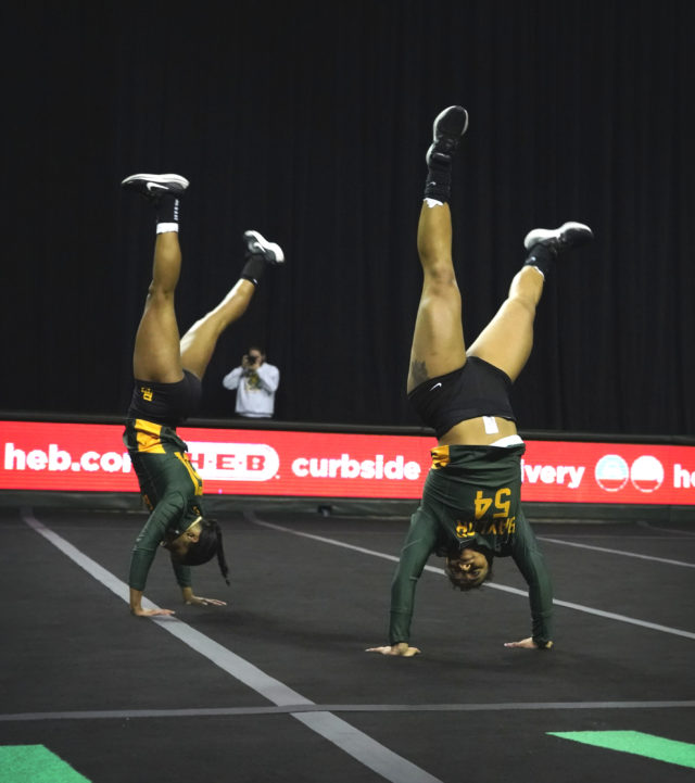 Sophomore tumbler Aliyah Kaloostian (54) does a cartwheel with a teammate during a meet against Presbyterian College, Sunday, Feb. 19, 2023, in the Ferrell Center. 
Grace Everett | Photographer