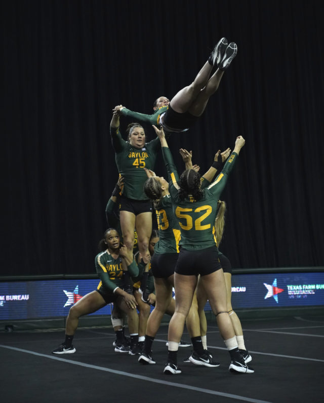 The Baylor acrobatics and tumbling team catches a teammate falling from above during a meet against Presbyterian College on Sunday in the Ferrell Center. Grace Everett | Photographer