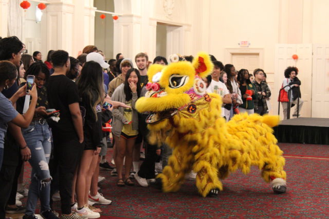 Students taking pictures with lion figure at ASA's 2022 Lunar new year celebration. Photo courtesy of Taylor Chung.