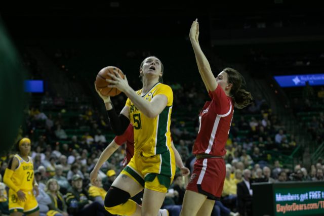 Fifth-year senior forward Caitlin Bickle (51) posts up and tries to shoot a layup during a conference game against Texas Tech University, Feb. 25, 2023, in the Ferrell Center.
Katy Mae Turner | Photographer