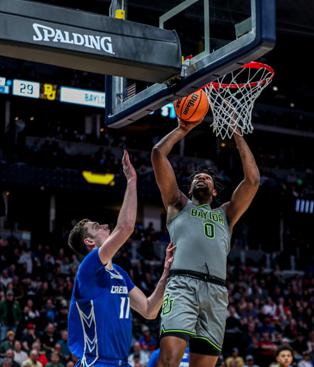 Fifth-year senior forward Flo Thamba (0) makes a layup over a Bluejay defender during No. 3 seed Baylor men's basketball's NCAA Tournament second round game against No. 6 Creighton University, on Sunday, in the Ball Arena, in Denver.
Kenneth Prabhakar | Photo Editor