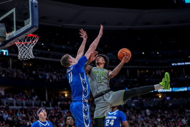 Junior forward Jalen Bridges (11) makes a contested layup over the Bluejays' junior center, Ryan Kalkbrenner (11) during No. 3 seed Baylor men's basketball's NCAA Tournament second round game against No. 6 Creighton University, on Sunday, in the Ball Arena, in Denver.
Kenneth Prabhakar | Photo Editor