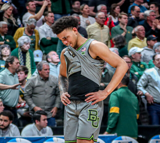 Freshman guard Keyonte George (1) bites his jersey in disappointment during No. 3 seed Baylor men's basketball's NCAA Tournament second round game against No. 6 seed Creighton University Sunday in the Ball Arena in Denver. Kenneth Prabhakar | Photo Editor