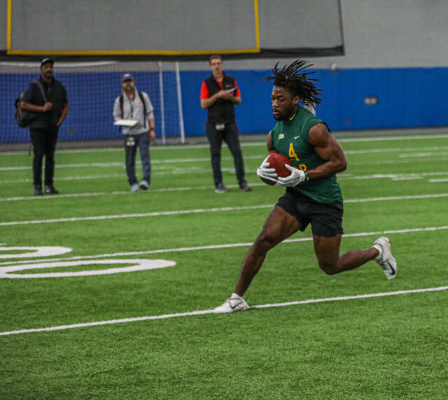 Safety Christian Morgan (4) digs his right cleat in the turf after catching a pass during Baylor football's Pro Day, on Monday, in Midway's Activity Center, in Hewitt.
Kenneth Prabhakar | Photo Editor