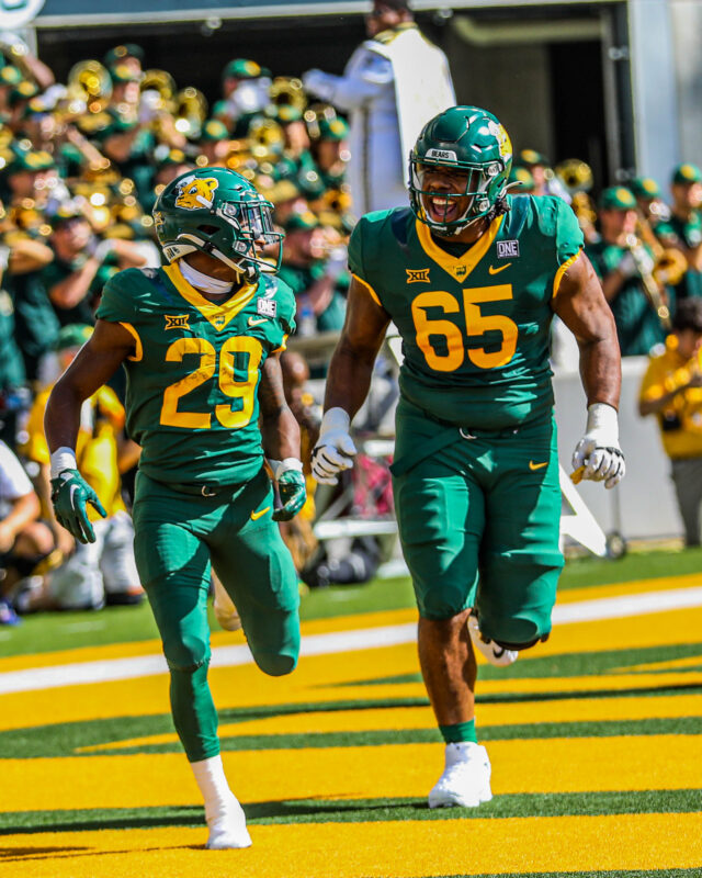 Freshman running back Richard Reese (29) and sixth-year senior offensive lineman Khalil Keith (65) celebrate a touchdown and run back toward the sideline during a conference game against the University of Kansas on Oct. 22, at McLane Stadium.
Kenneth Prabhakar | Photographer