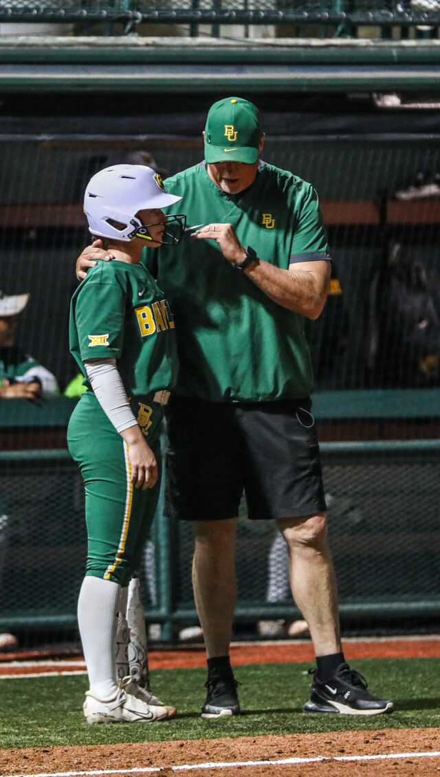 Head coach Glenn Moore talks with one of his athletes during a non-conference midweek contest against the University of Texas at Arlington, on Feb. 28, at Getterman Stadium. 
Kenneth Prabhakar | Photo Editor