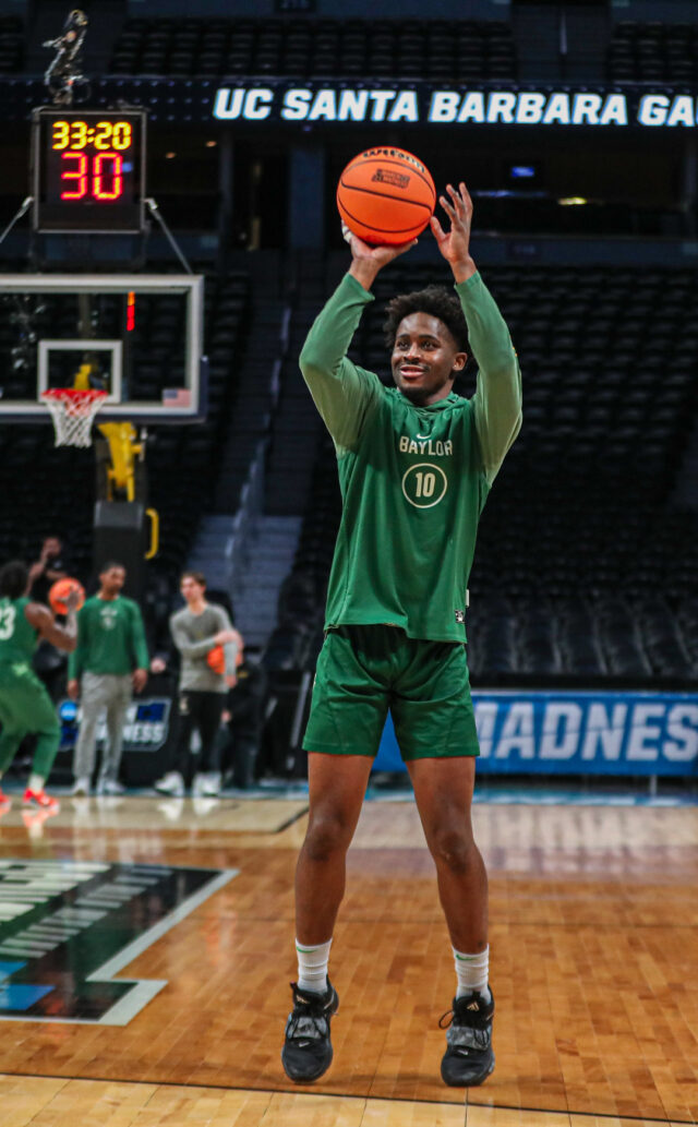 Redshirt senior guard Adam Flagler (10) smiles as he shoots a 3-pointer from the left wing during No. 3 seed Baylor men's basketball's team practice ahead of its round of 64 contest against the University of California, Santa Barbara, on Thursday, in the Ball Arena, in Denver. 
Kenneth Prabhakar | Photo Editor