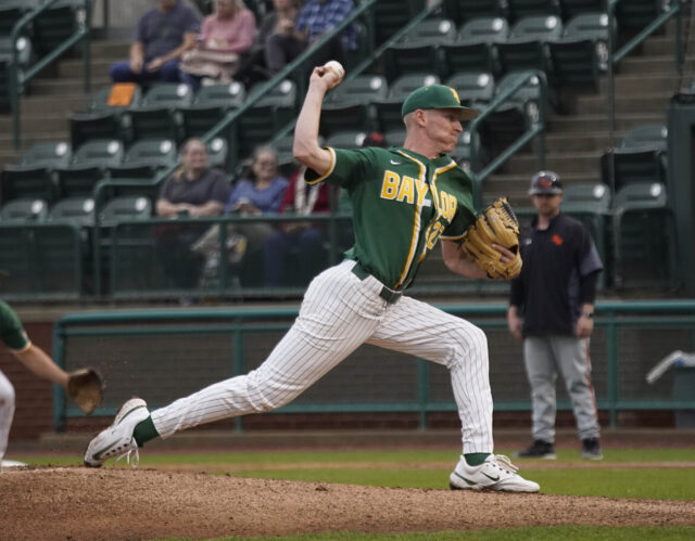 Junior right-handed pitcher Jared Matheson (27) lunges forward and hurles a pitch toward sophomore catcher Cortlan Castle during Baylor baseball's non-conference contest against Sam Houston State University, on Tuesday, at Baylor Ballpark.
Grace Everett | Photographer