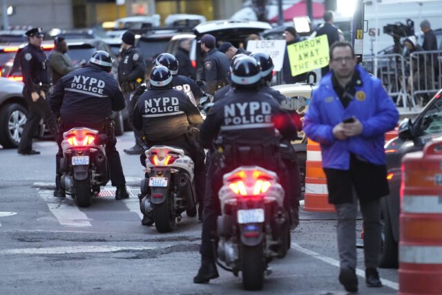 New York City police officers on scooters line up outside Manhattan criminal courts building Thursday in New York. (AP Photo/Mary Altaffer)