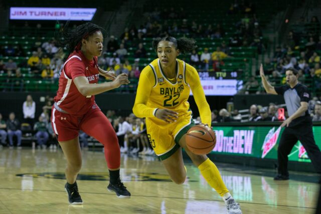 Freshman forward Bella Fontleroy (22) blows by her Lady Raider defender during a conference game against Texas Tech University, Saturday, in the Ferrell Center.
Katy Mae Turner | Photographer