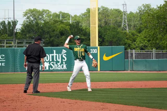 Freshman infielder Kolby Branch (13) tosses the ball back to the pitcher during Baylor baseball's midweek contest against Tarleton State University Tuesday afternoon at Baylor Ballpark. Olivia Havre | Photographer