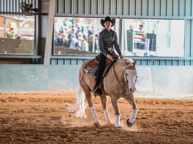 Fifth-year senior Western rider Madaline Callaway scurries through the arena during No. 8 Baylor equestrian's conference contest against No. 7 Oklahoma State University on Feb. 18 at the Willis Family Equestrian Center. Kenneth Prabhakar | Photo Editor