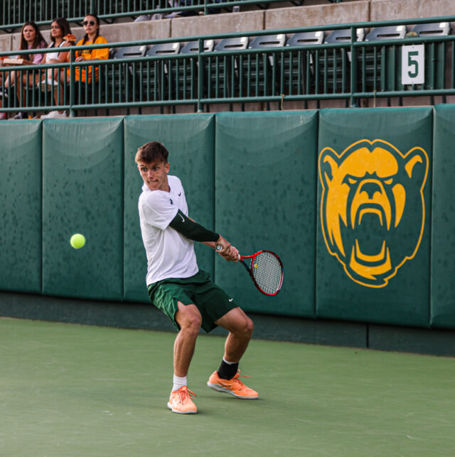 Sophomore Ethan Muza zeros in on the ball and readies to return it during Baylor men's tennis' Saturday doubleheader against the University of Texas Rio Grande Valley and Texas Tech University on April 1 at the Hurd Tennis Center. Kenneth Prabhakar | Photo Editor