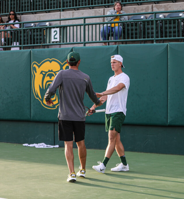 Head coach Michael Woodson (left) high fives one of his athletes during Baylor men's tennis' Saturday doubleheader against the University of Texas Rio Grande Valley and Texas Tech University, at the Hurd Tennis Center.
Kenneth Prabhakar | Photo Editor