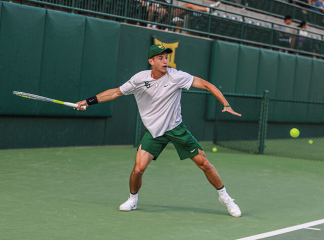 Junior Tadeas Paroulek extends and swings toward the ball during Baylor men's tennis' Saturday doubleheader against the University of Texas Rio Grande Valley and Texas Tech University on April 1 at the Hurd Tennis Center. Kenneth Prabhakar | Photo Editor
