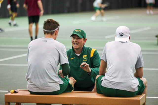 Head coach Michael Woodson (middle) talks over the game plan with doubles partners Ethan Muza (left) and freshman Luc Koenig (right) during No. 12 Baylor men's tennis' second round match of the ITA Kickoff Weekend against No. 9 Florida State University on Jan. 28 in the Hawkins Indoor Tennis Center.
Kenneth Prabhakar | Photo Editor