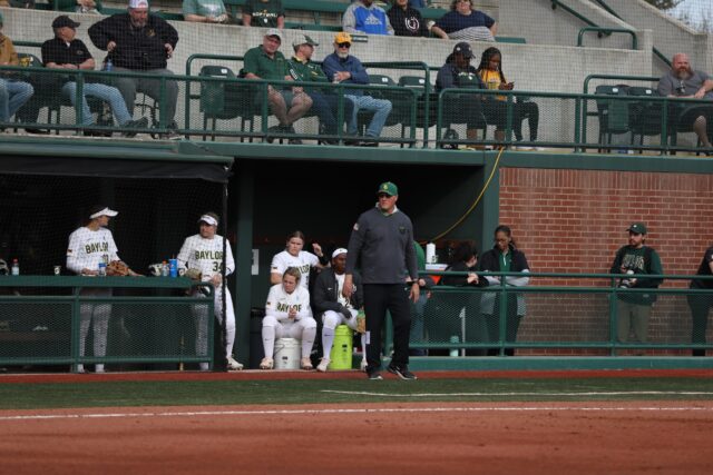 Head coach Glenn Moore (middle) watches his team from the third base coaching spot during the final game of the Getterman Classic against the United States Military Academy on Feb. 19 at Getterman Stadium. Kenneth Prabhakar | Photo Editor