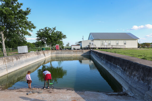 The children that live on the remains of the Branch Davidian compound play in what is left of the pool thirty years later. The ash marks from the fire can be seen surrounding the borders of the inner pool wall. Kenneth Prabhakar | Photo Editor
