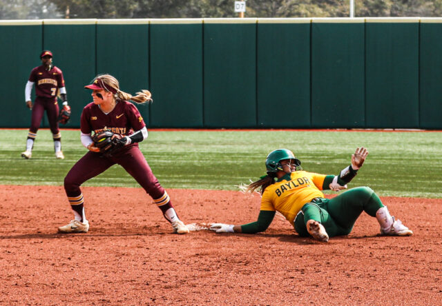 Sophomore infielder Shaylon Govan (12) tries to lunge to the second base bag, but is called out by the umpire, during the championship game of the Baylor Invitational against the University of Minnesota on Feb. 26 at Getterman Stadium.
Kenneth Prabhakar | Photo Editor
