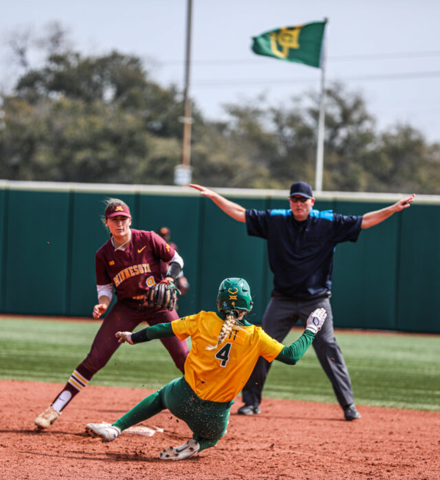 Junior utility Emily Hott (4) slides into second base as she's called safe by one of the officials during the championship game of the Baylor Invitational against the University of Minnesota on Feb. 26 at Getterman Stadium.
Kenneth Prabhakar | Photo Editor