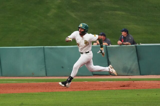 Junior outfielder Hunter Simmons (9) rounds first base and heads toward second during Baylor baseball's midweek contest against Stephen F. Austin State University on Tuesday at Baylor Ballpark.
Olivia Havre | Photographer