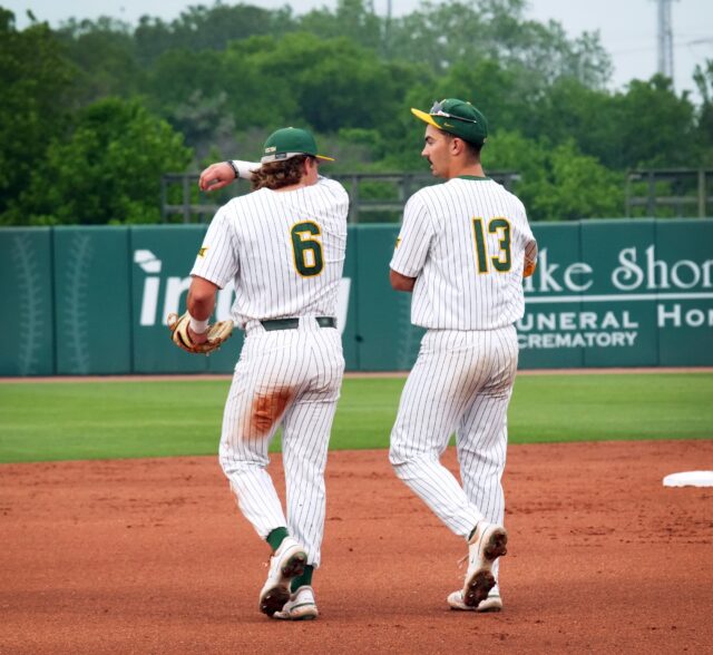 Junior infielder and outfielder Cole Posey (6, left) and freshman infielder Kolby Branch (13, right) talk things over during Baylor baseball's midweek contest against Stephen F. Austin State University on Tuesday at Baylor Ballpark.
Olivia Havre | Photographer