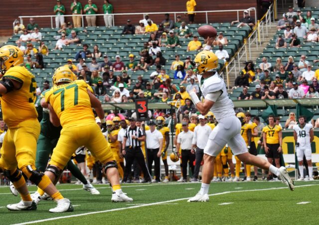 Redshirt sophomore quarterback Sawyer Robertson (13) throws the football over the middle of the field during Baylor football's annual Green & Gold scrimmage Saturday at McLane Stadium.
Olivia Havre | Photographer