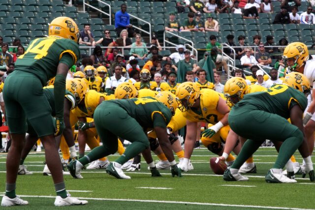 The Baylor football team lines up at the line of scrimmage during its annual Green & Gold scrimmage on Saturday at McLane Stadium.Olivia Havre | Photographer