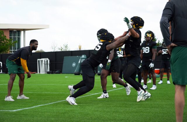 Redshirt sophomore defensive lineman Jackie Marshall (left, 35) pushes fifth-year senior defensive lineman TJ Franklin (right, 9) as part of a drill during Baylor football's second practice of the spring, on March 23 at the team's practice field.
Olivia Havre | Photographer