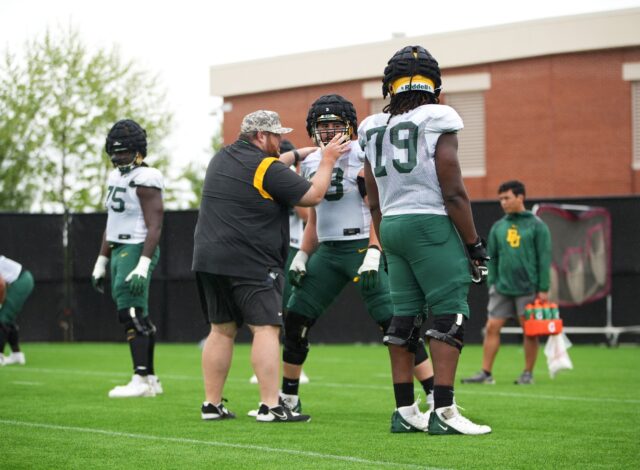 Offensive line coach Eric Mateos adjusts one of his athlete's positioning for a drill during Baylor football's seventh practice of the spring Thursday at the team's outdoor practice field.
Olivia Havre | Photographer
