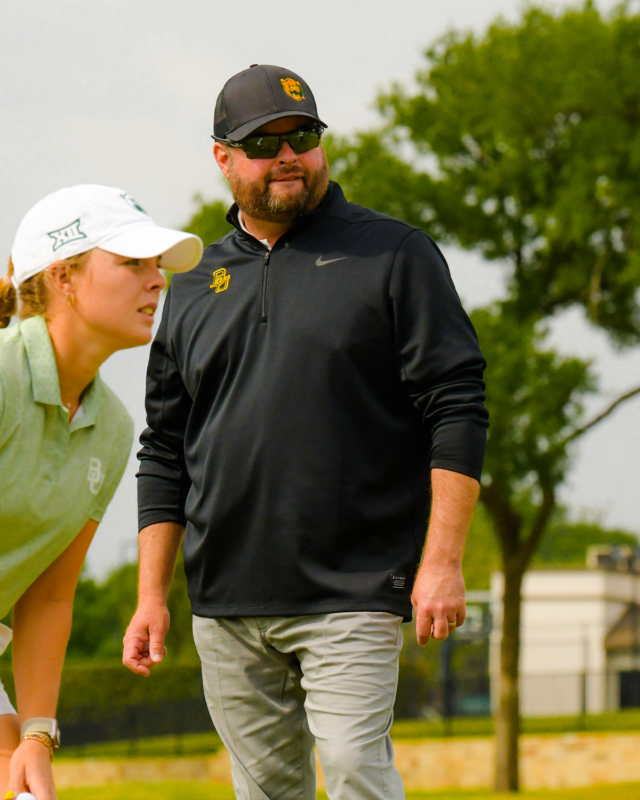 Head coach Jay Goble assists junior Rosie Belsham in her plan for part of the course during No. 13 Baylor women's golf's first day the Big 12 Championship on Friday at the Dallas Athletic Club in Dallas.
Photo courtesy of Baylor Athletics