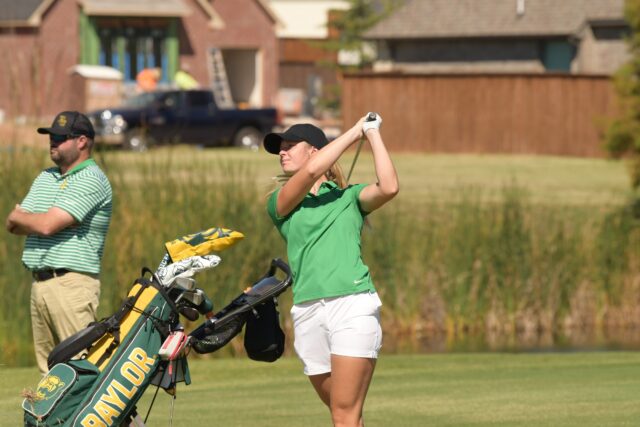 Freshman Silje Ohma (right) takes a swing while No. 12 Baylor women's golf head coach Jay Goble (left) watches.
Photo courtesy of Baylor Athletics