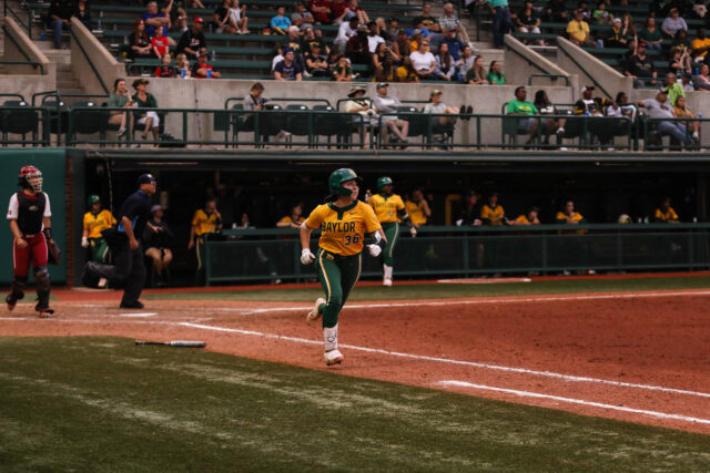 Sophomore infielder Amber Toven (36) heads toward first base after making contact with the ball during No. 16 Baylor softball’s conference doubleheader against No. 1 University of Oklahoma Saturday at Getterman Stadium. Assoah Ndomo | Photographer