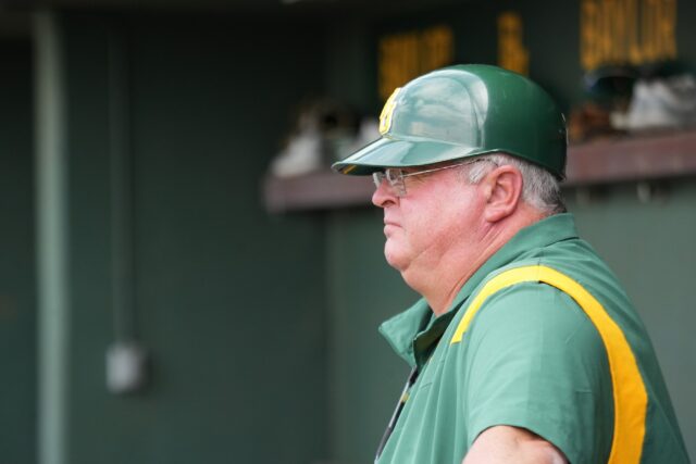 Head coach Mitch Thompson watches his team from the dugout during Baylor baseball's midweek contest against Tarleton State University Tuesday afternoon at Baylor Ballpark. Olivia Havre | Photographer