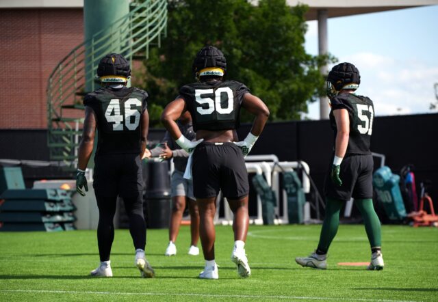 Junior outside linebacker Tony Anyanwu (46, left), redshirt freshman defensive lineman Kaian Roberts-Day (50) and redshirt freshman outside linebacker Kyler Jordan (51) walk toward outside linebacker coach Caleb Collins during Baylor football's ninth day of spring practice on Tuesday at the team's outdoor practice field.
Olivia Havre | Photographer