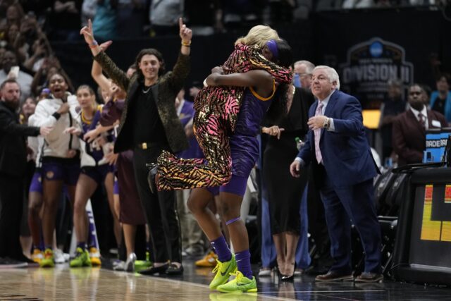 LSU head coach Kim Mulkey celebrates with Flau'jae Johnson during the second half of the NCAA Women's Final Four championship basketball game Sunday in Dallas. LSU won 102-85 to win the championship. (AP Photo/Tony Gutierrez)