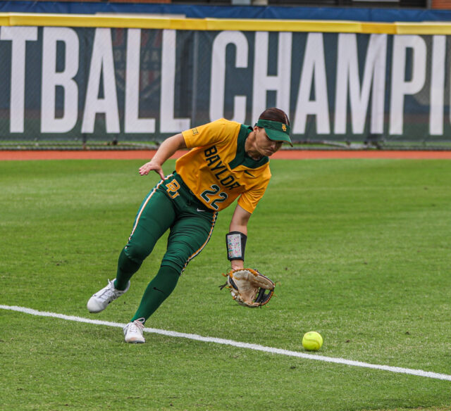 Junior outfielder Ana Watson (22) scoops the ball off the left field line during No. 4 seed Baylor softball's first round game against No. 5 seed Iowa State University as part of the Phillips 66 Big 12 Softball Championship on Thursday at USA Softball Hall of Fame Stadium in Oklahoma City.
Michael Haag | Sports Editor